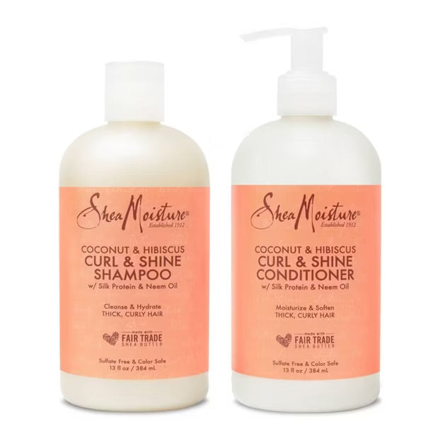 Two bottles of SheaMoisture Coconut & Hibiscus Curl & Shine hair products, available at Jazz Beauty Supply in Detroit. Shampoo is on the left and conditioner on the right, both with ivory backgrounds and pink-orange labels.