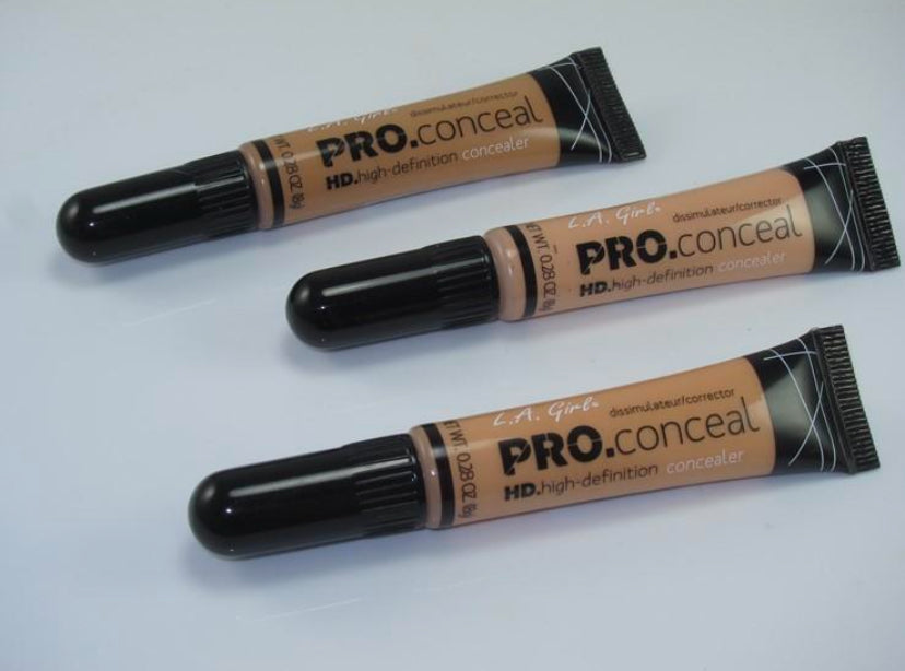 Three tubes of L.A. Girl PRO.conceal HD high-definition concealer are arranged diagonally on a white surface, just like youd find at Jazz Beauty Supply in Detroit, with the caps facing left and the applicator ends facing right.